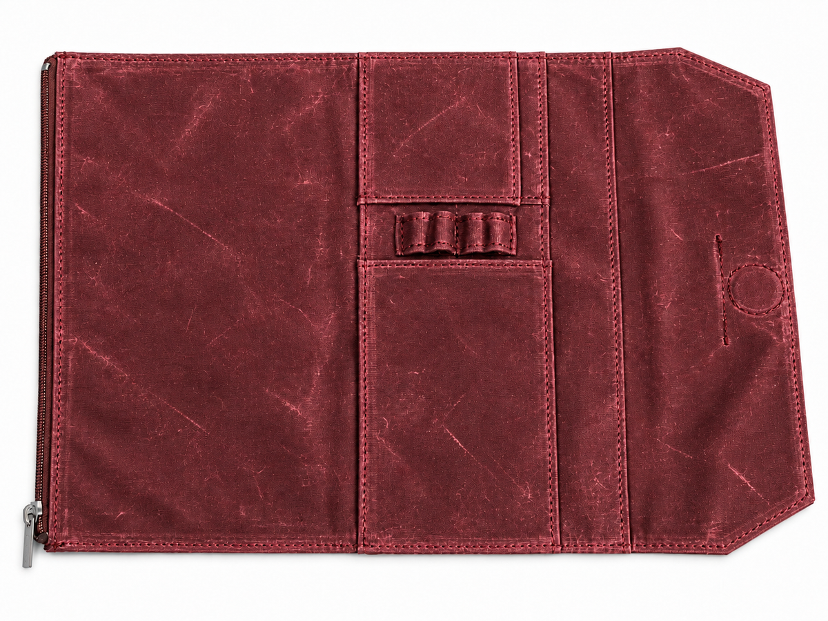 Studio Case waxed canvas pencil case in Campfire, open flat showing interior pen loops and card pocket