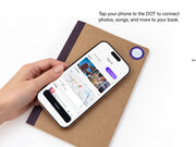 Tapping a phone to the DOT tag on a Dusk notebook cover to connect photos, songs, and locations